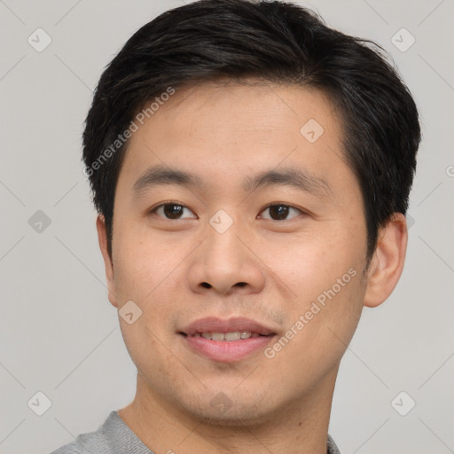 Joyful asian young-adult male with short  brown hair and brown eyes