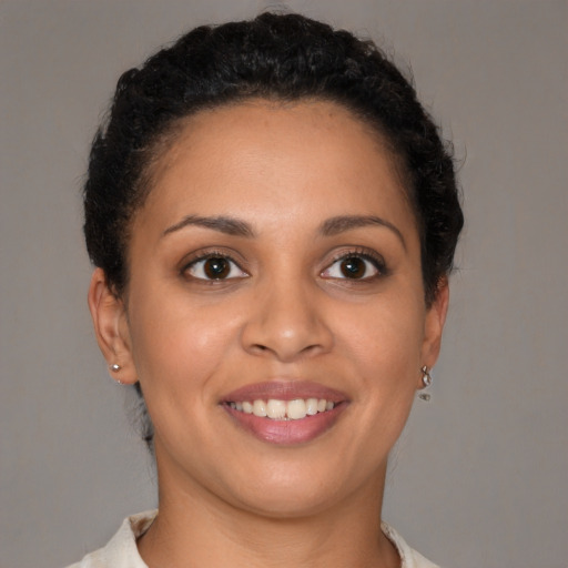 Joyful latino young-adult female with short  brown hair and brown eyes