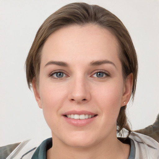 Joyful white young-adult female with medium  brown hair and grey eyes