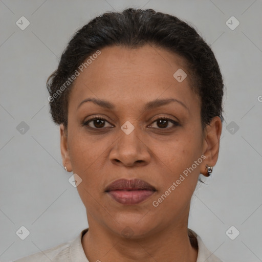 Joyful latino adult female with short  brown hair and brown eyes