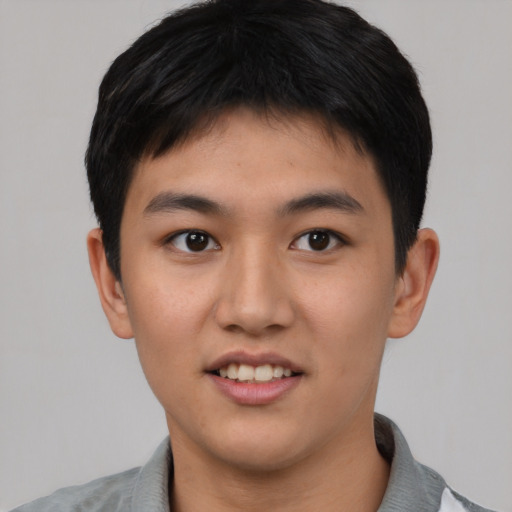 Joyful asian young-adult male with short  brown hair and brown eyes