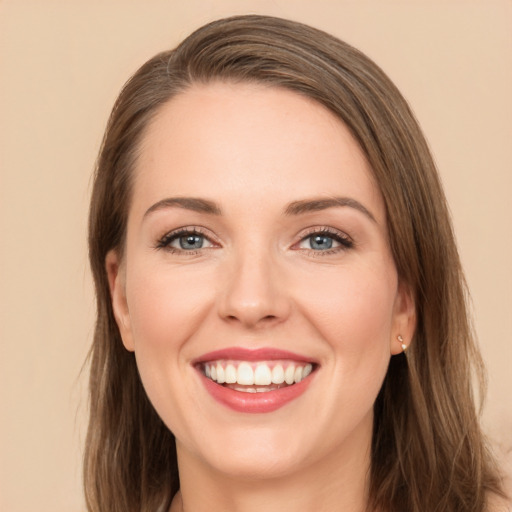 Joyful white young-adult female with long  brown hair and brown eyes