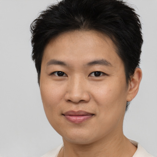 Joyful asian young-adult female with short  brown hair and brown eyes