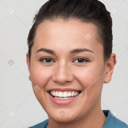 Joyful white young-adult female with short  brown hair and brown eyes