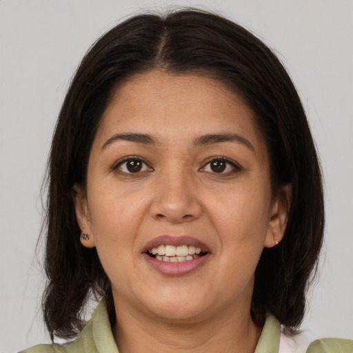 Joyful asian young-adult female with medium  brown hair and brown eyes