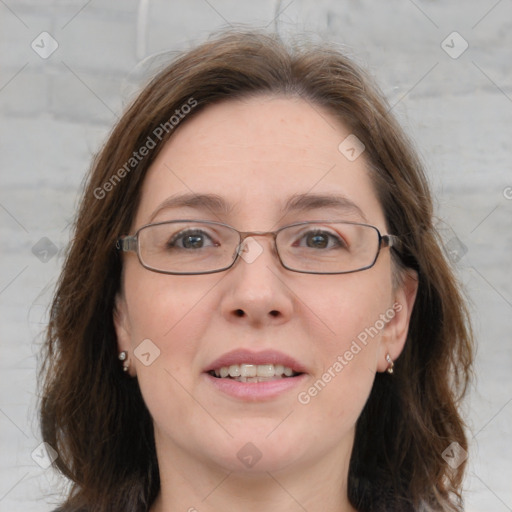 Joyful white adult female with medium  brown hair and blue eyes