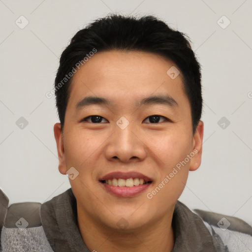 Joyful asian young-adult male with short  black hair and brown eyes