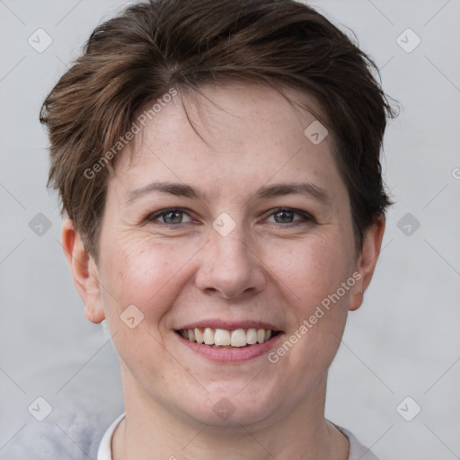 Joyful white young-adult female with short  brown hair and grey eyes