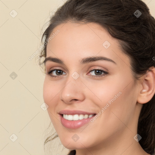 Joyful white young-adult female with long  brown hair and brown eyes