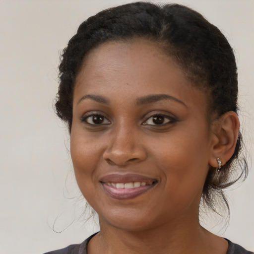 Joyful black young-adult female with medium  brown hair and brown eyes