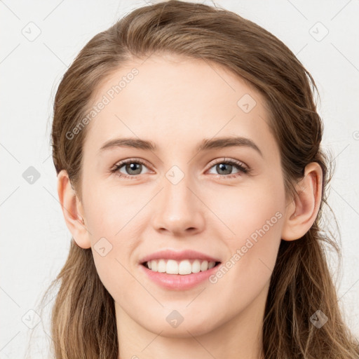 Joyful white young-adult female with long  brown hair and grey eyes