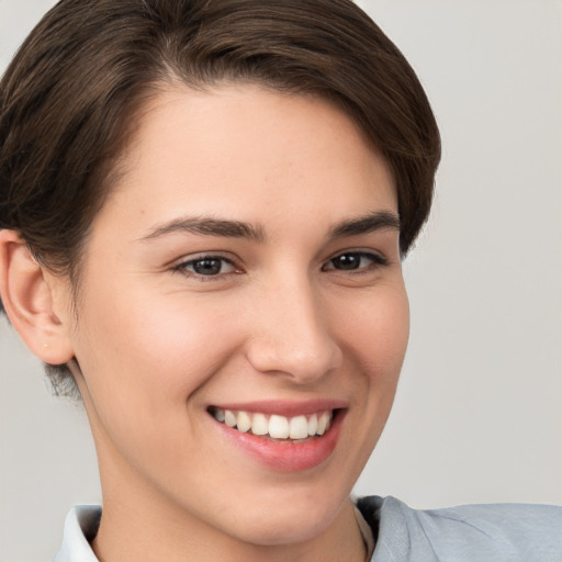 Joyful white young-adult female with short  brown hair and brown eyes