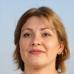 Joyful white adult female with medium  brown hair and brown eyes