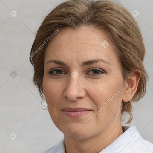 Joyful white adult female with medium  brown hair and brown eyes