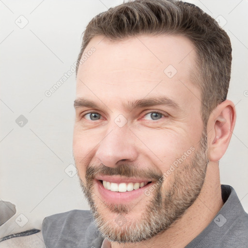 Joyful white adult male with short  brown hair and grey eyes