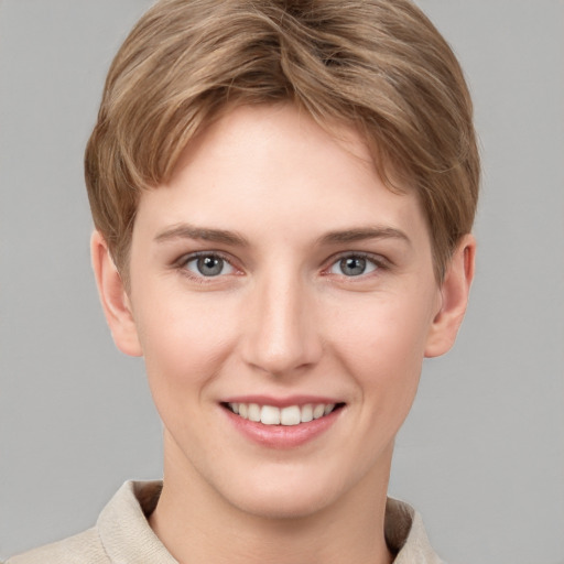 Joyful white young-adult female with short  brown hair and grey eyes