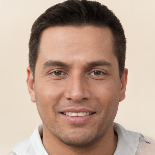 Joyful white young-adult male with short  brown hair and brown eyes