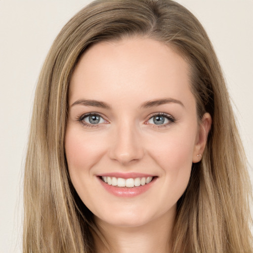 Joyful white young-adult female with long  brown hair and green eyes