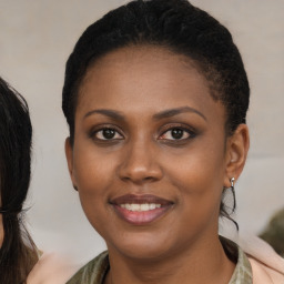 Joyful black young-adult female with medium  brown hair and brown eyes