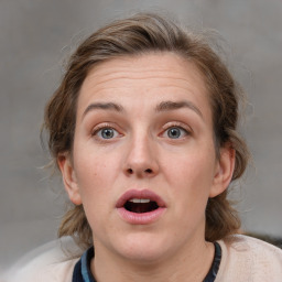 Joyful white adult female with medium  brown hair and grey eyes