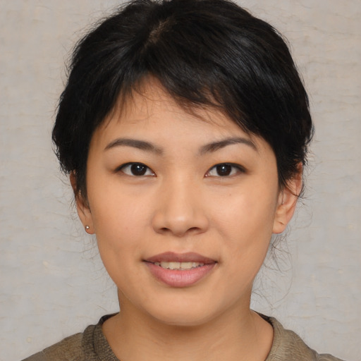 Joyful asian young-adult female with medium  brown hair and brown eyes