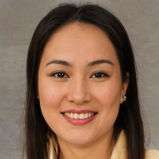 Joyful latino young-adult female with long  brown hair and brown eyes