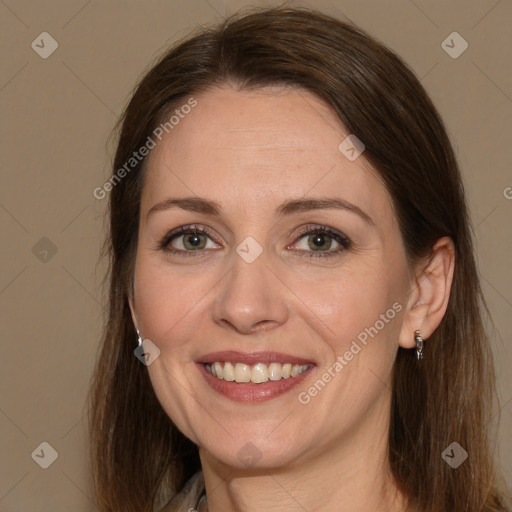 Joyful white adult female with long  brown hair and brown eyes