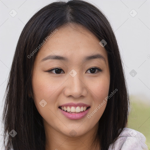 Joyful asian young-adult female with long  brown hair and brown eyes