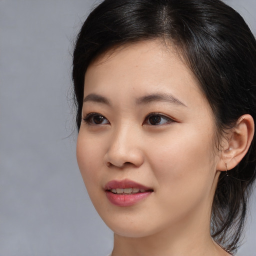 Joyful asian young-adult female with medium  brown hair and brown eyes