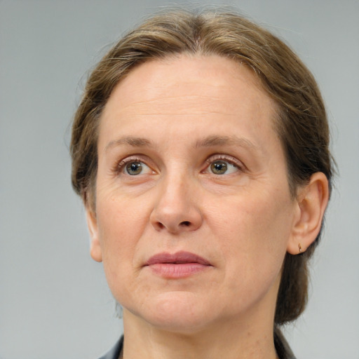 Joyful white adult female with medium  brown hair and grey eyes