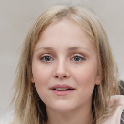 Joyful white young-adult female with medium  brown hair and blue eyes