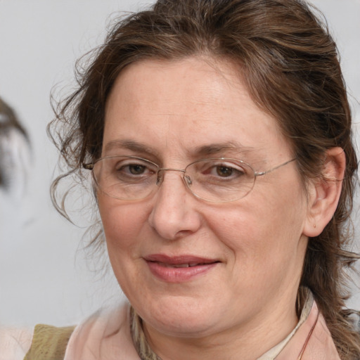 Joyful white adult female with medium  brown hair and blue eyes