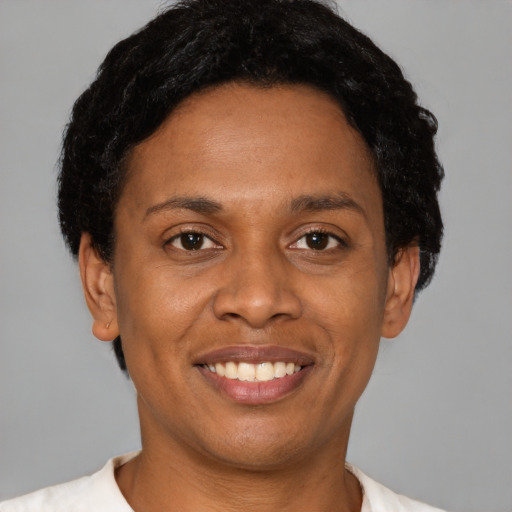 Joyful latino young-adult female with short  black hair and brown eyes