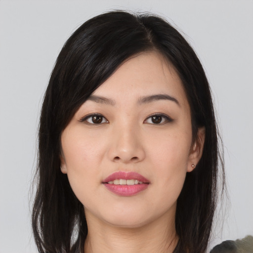 Joyful asian young-adult female with long  black hair and brown eyes