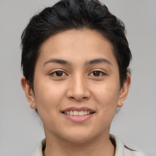 Joyful latino young-adult female with short  brown hair and brown eyes