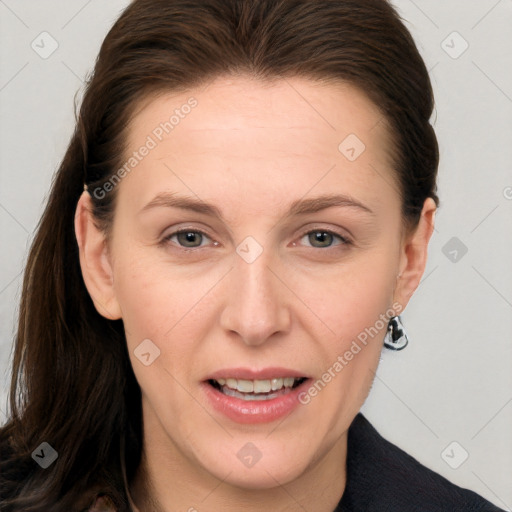 Joyful white adult female with long  brown hair and grey eyes