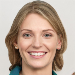 Joyful white young-adult female with medium  brown hair and blue eyes