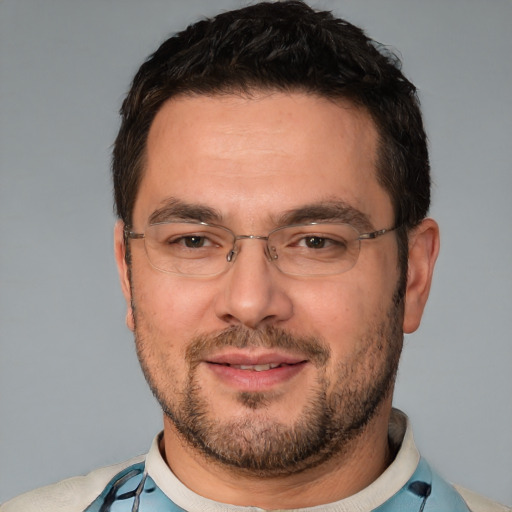 Joyful white adult male with short  black hair and brown eyes