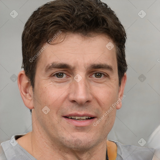 Joyful white adult male with short  brown hair and grey eyes