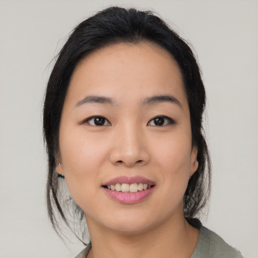 Joyful asian young-adult female with medium  black hair and brown eyes