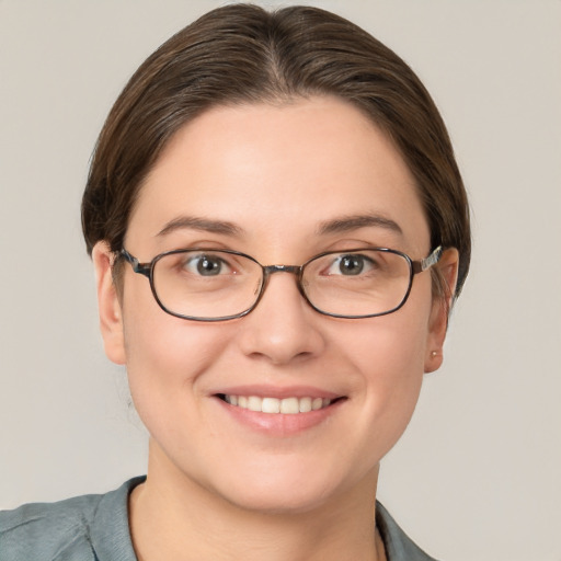 Joyful white young-adult female with short  brown hair and grey eyes