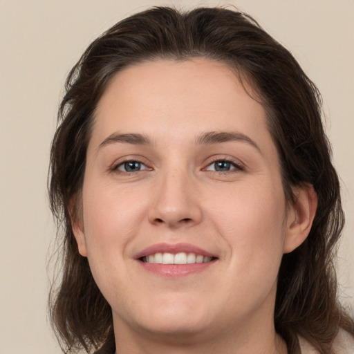 Joyful white young-adult female with medium  brown hair and brown eyes