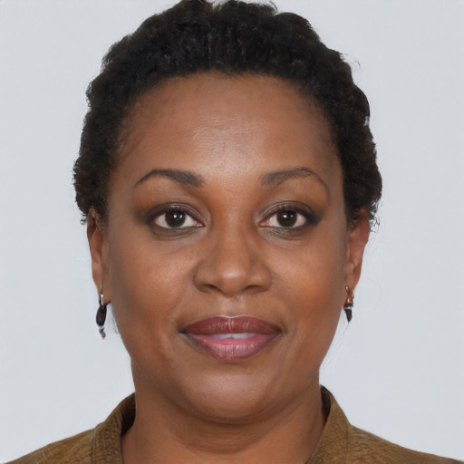 Joyful black adult female with short  brown hair and brown eyes