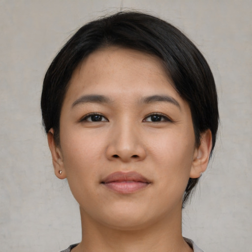 Joyful asian young-adult female with short  brown hair and brown eyes