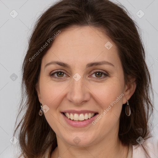 Joyful white adult female with long  brown hair and brown eyes