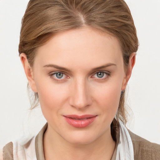 Joyful white young-adult female with medium  brown hair and blue eyes