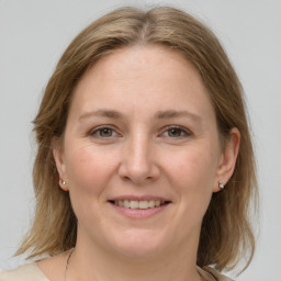 Joyful white adult female with medium  brown hair and grey eyes