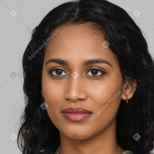 Joyful black young-adult female with long  black hair and brown eyes