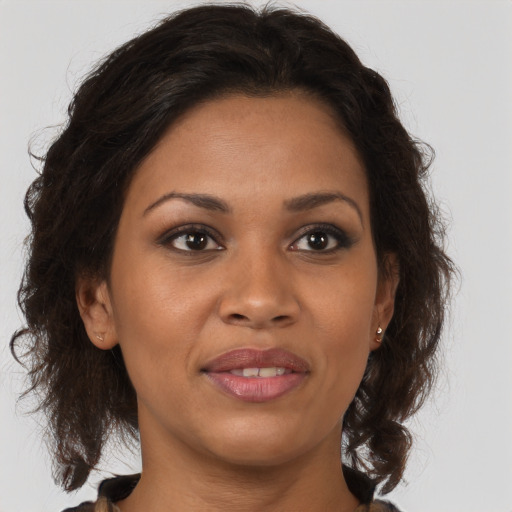 Joyful black young-adult female with medium  brown hair and brown eyes