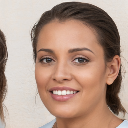 Joyful white young-adult female with medium  brown hair and brown eyes